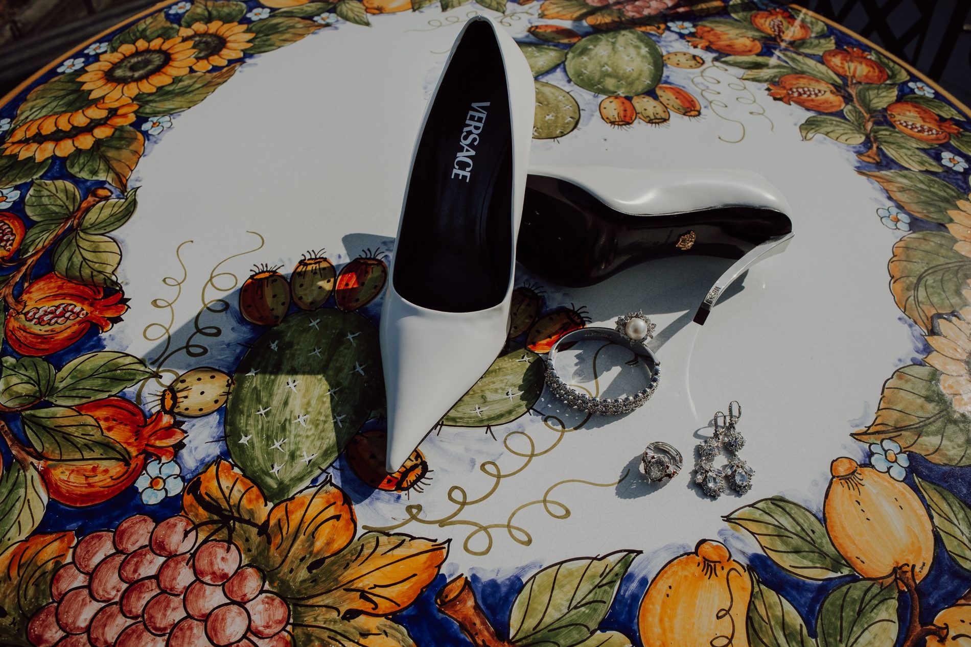 The bride's Versace heels on a hand-painted Sicilian plate