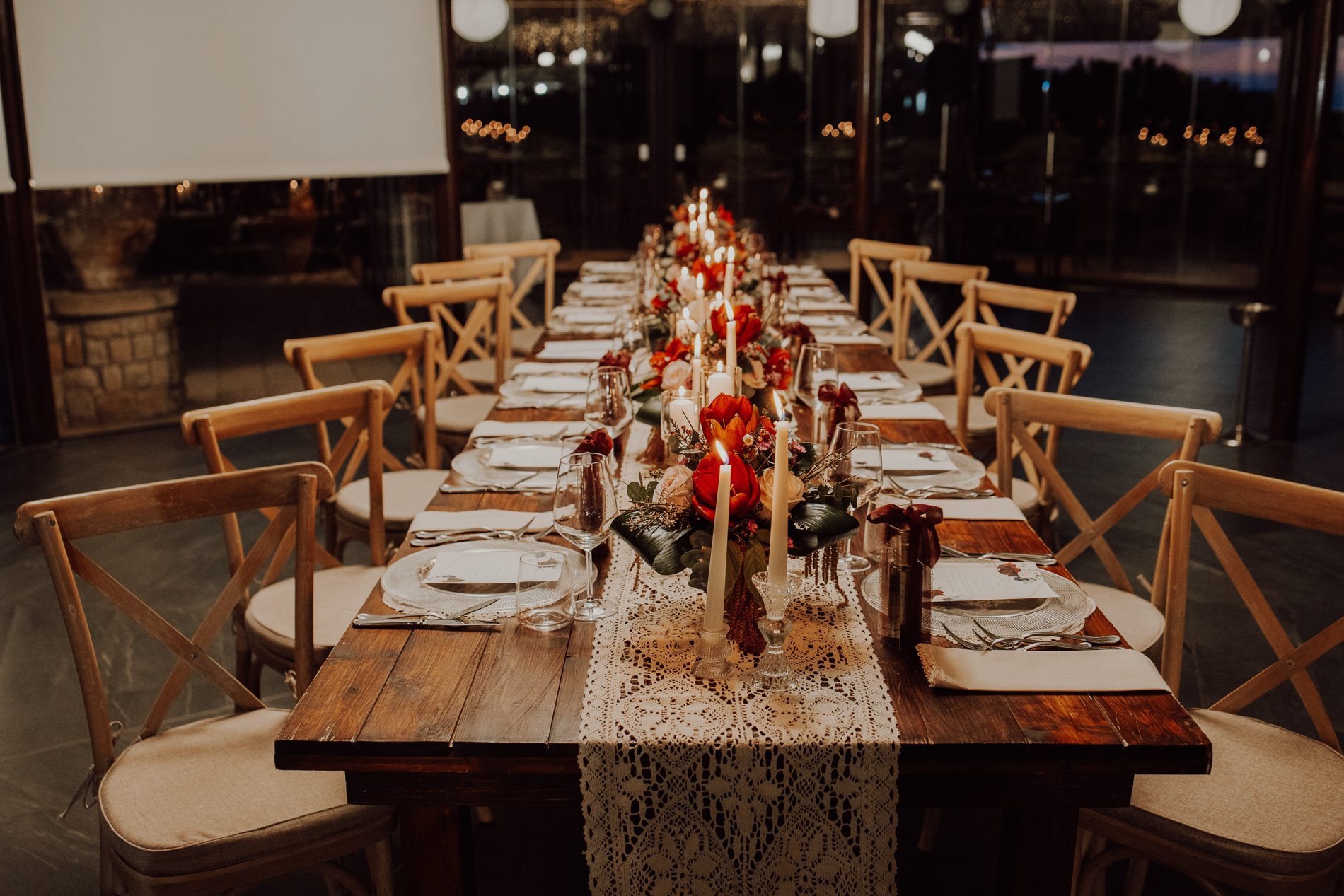 The long dinner table — wood, lace and candlelight