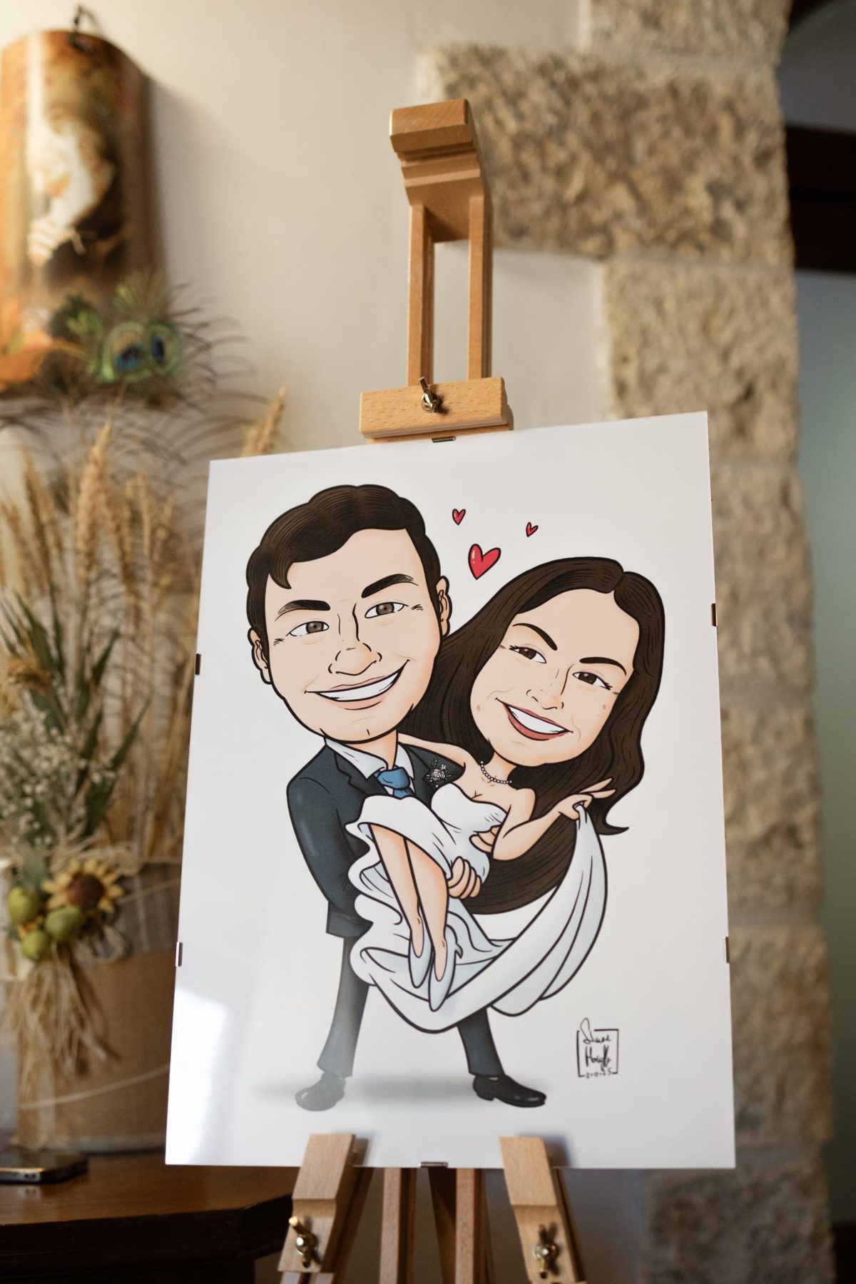 Hand-drawn caricature of the couple on an easel