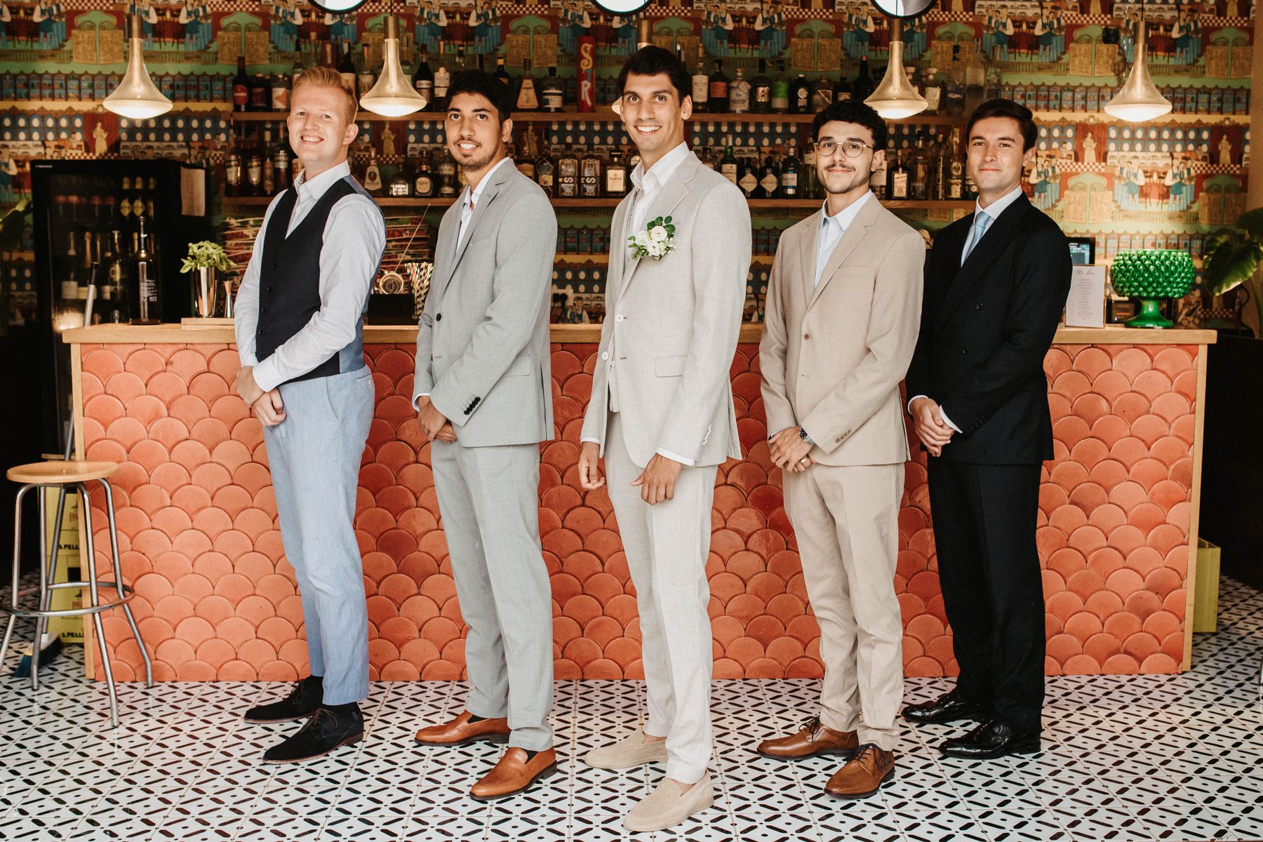The groom and his groomsmen at the colourful maiolica bar