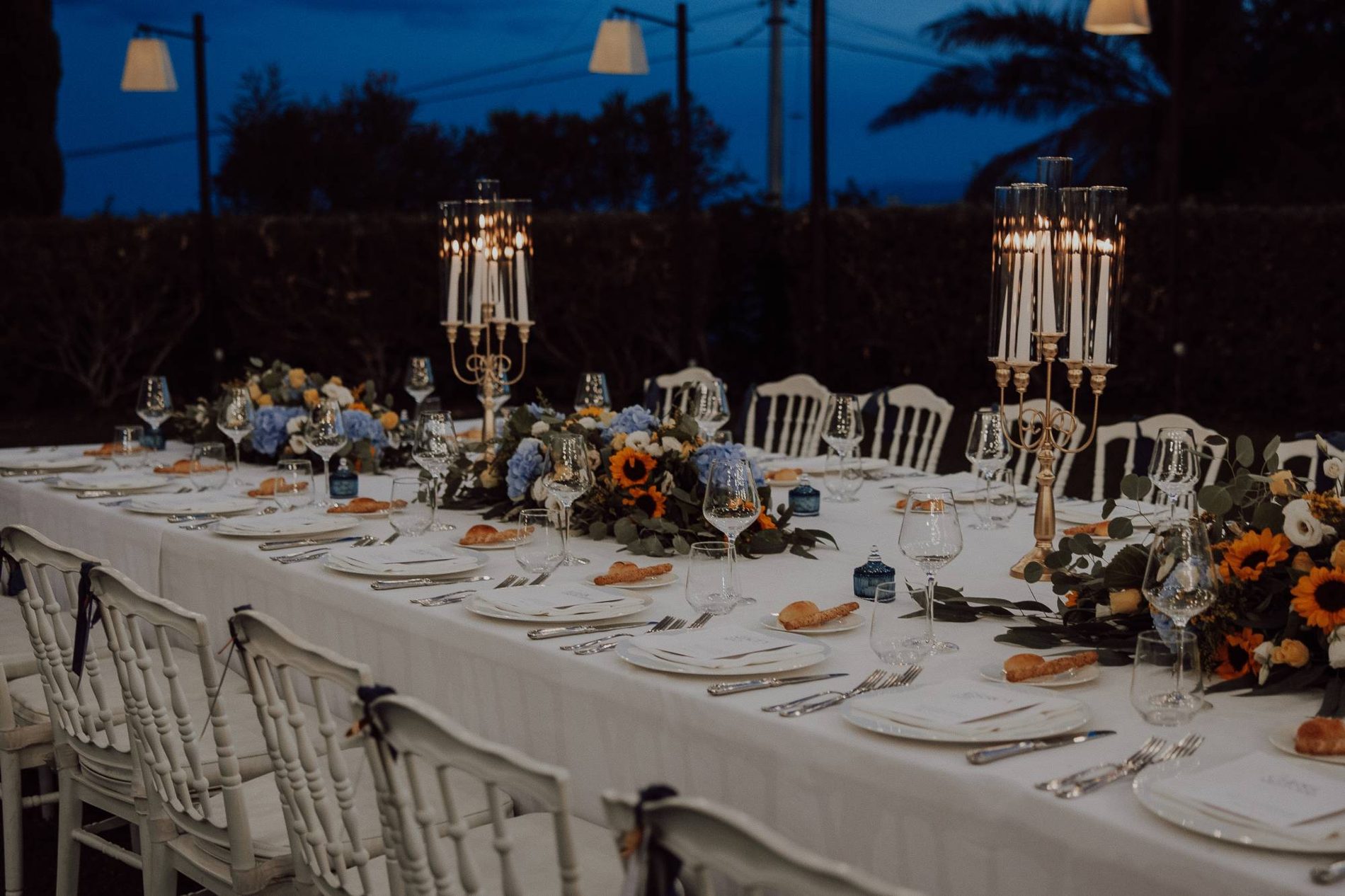The dinner table at blue hour — sunflowers, hydrangea and candlelight