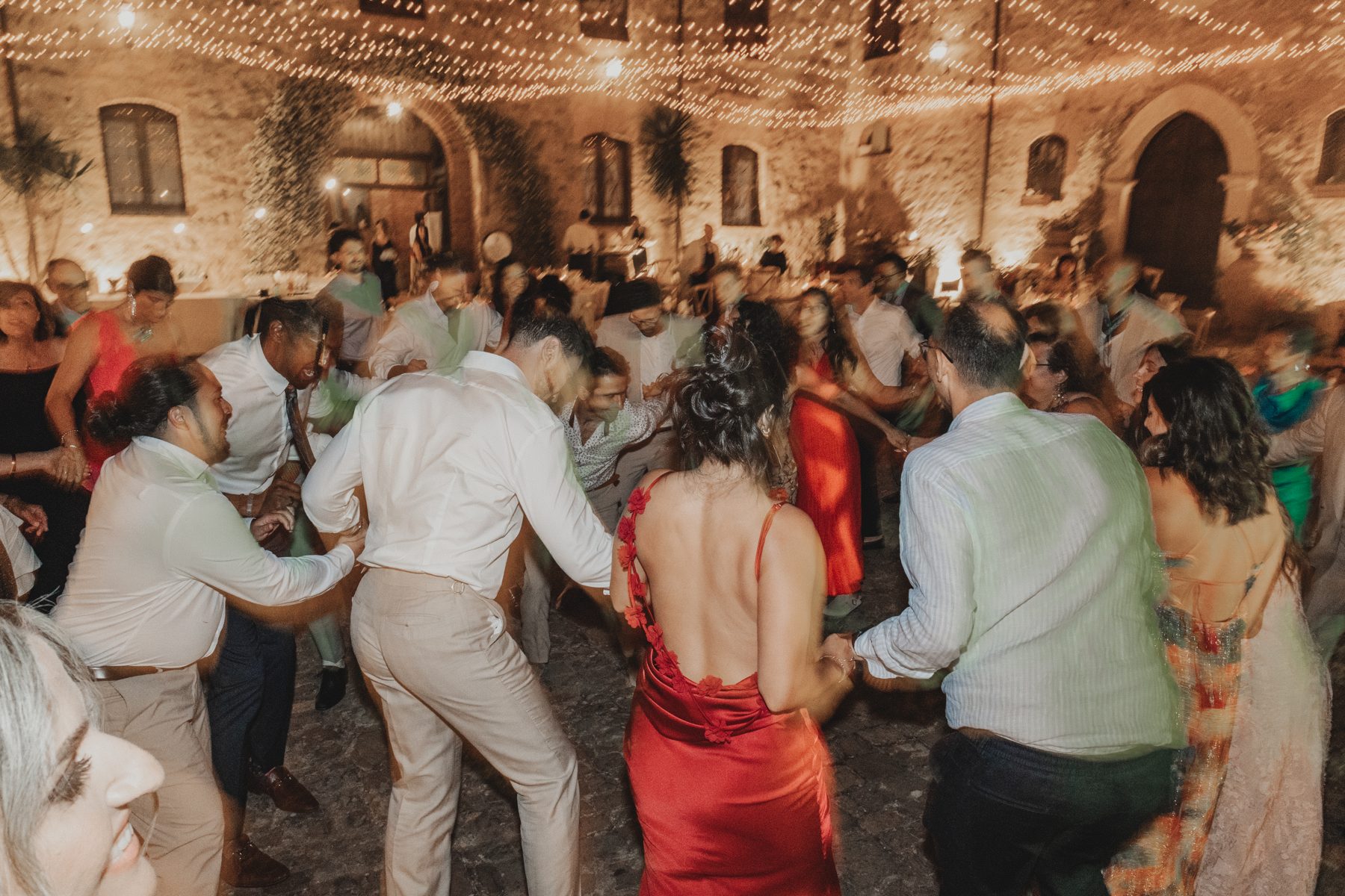 Traditional Armenian dancing under a canopy of fairy lights in the baglio