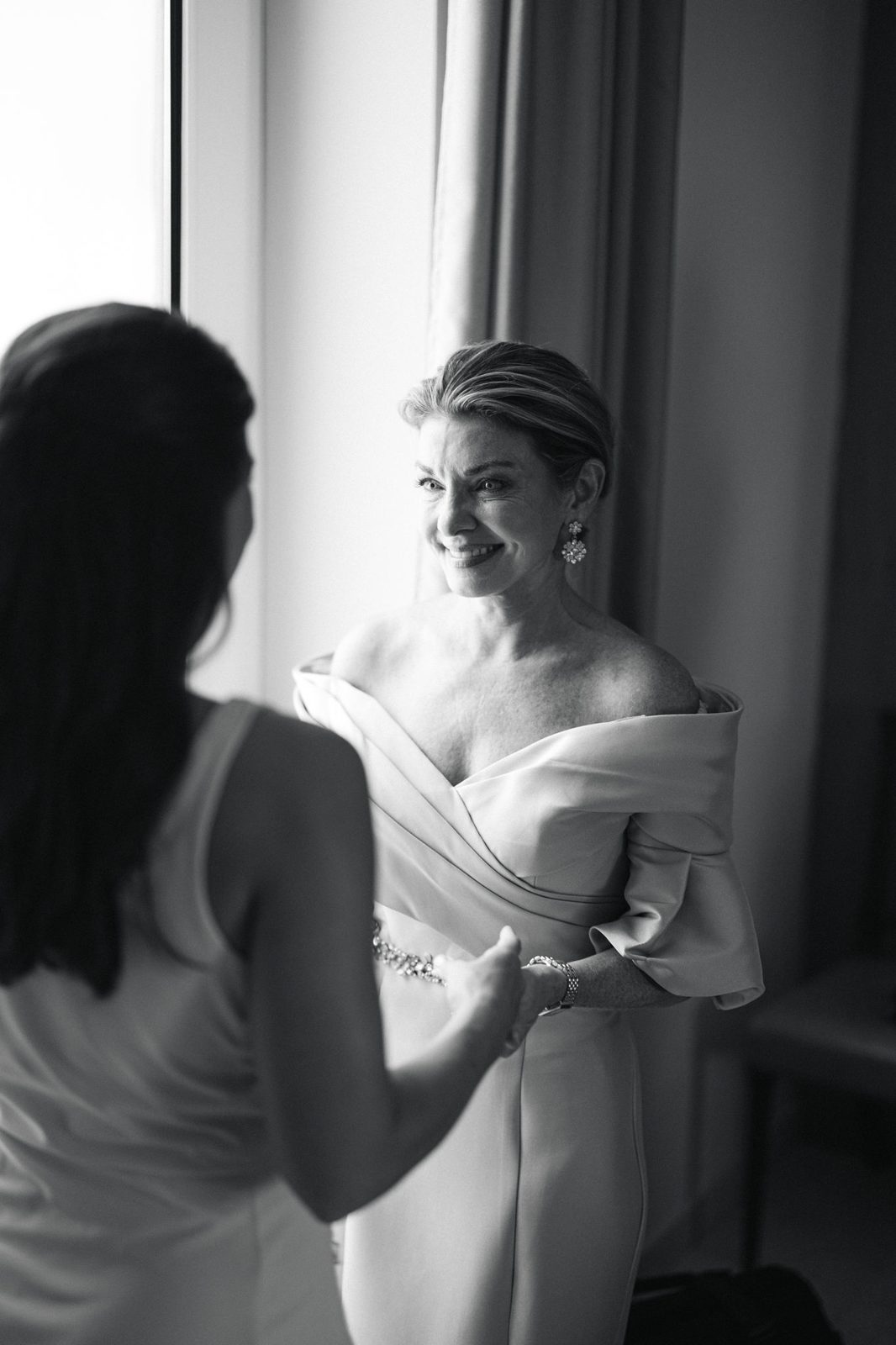A quiet getting-ready moment in window light