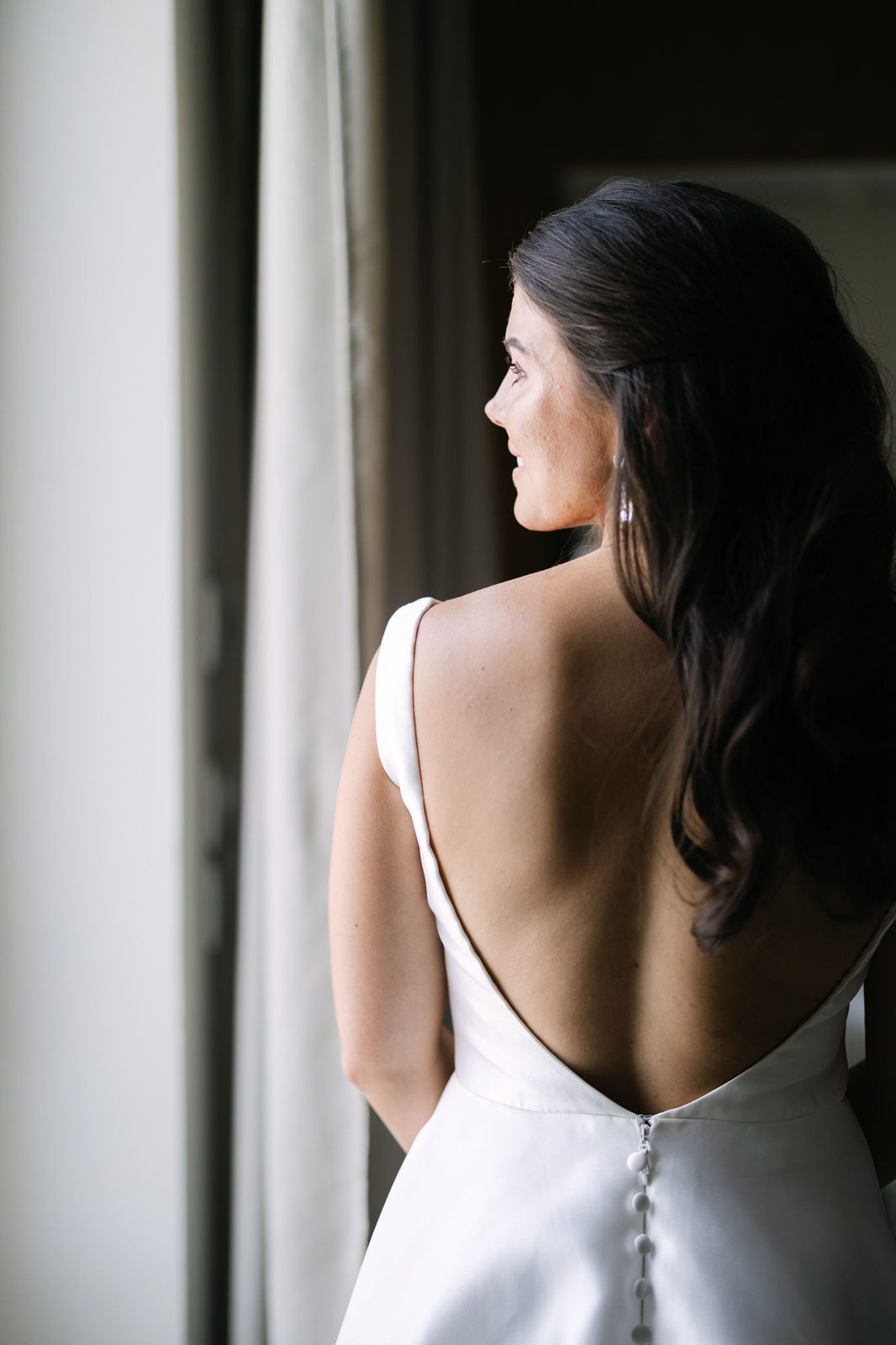 The low-backed gown, caught in the morning light