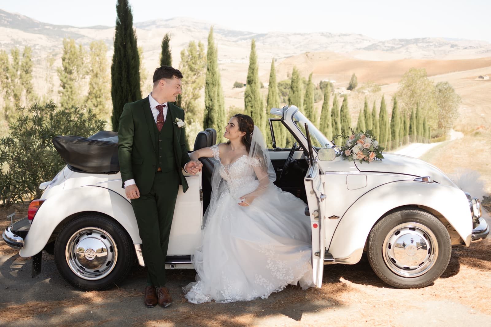 Couple with a vintage Beetle in the Madonie hills